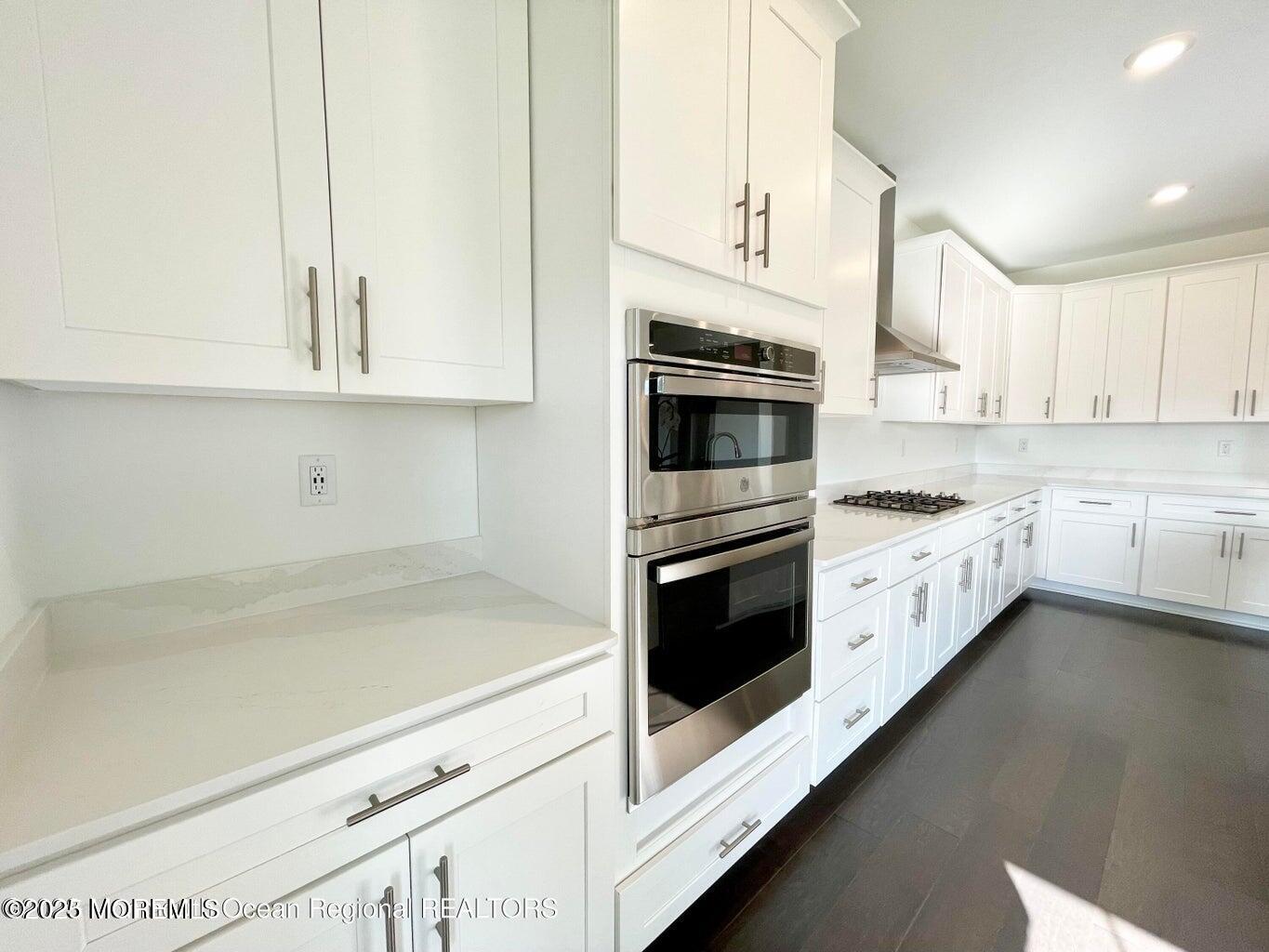 106 Woolley Court Oakhurst, NJ 07755 - Photo 11 of 17 a kitchen with stainless steel appliances white cabinets and a sink