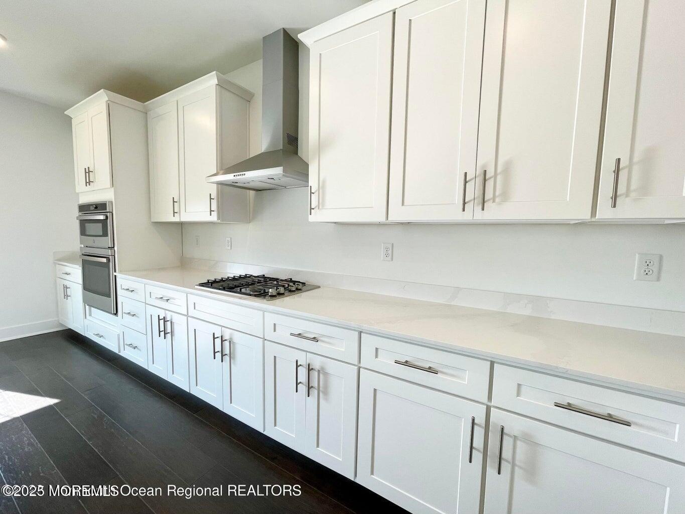 106 Woolley Court Oakhurst, NJ 07755 - Photo 12 of 17 a kitchen with stainless steel appliances granite countertop white cabinets and a sink