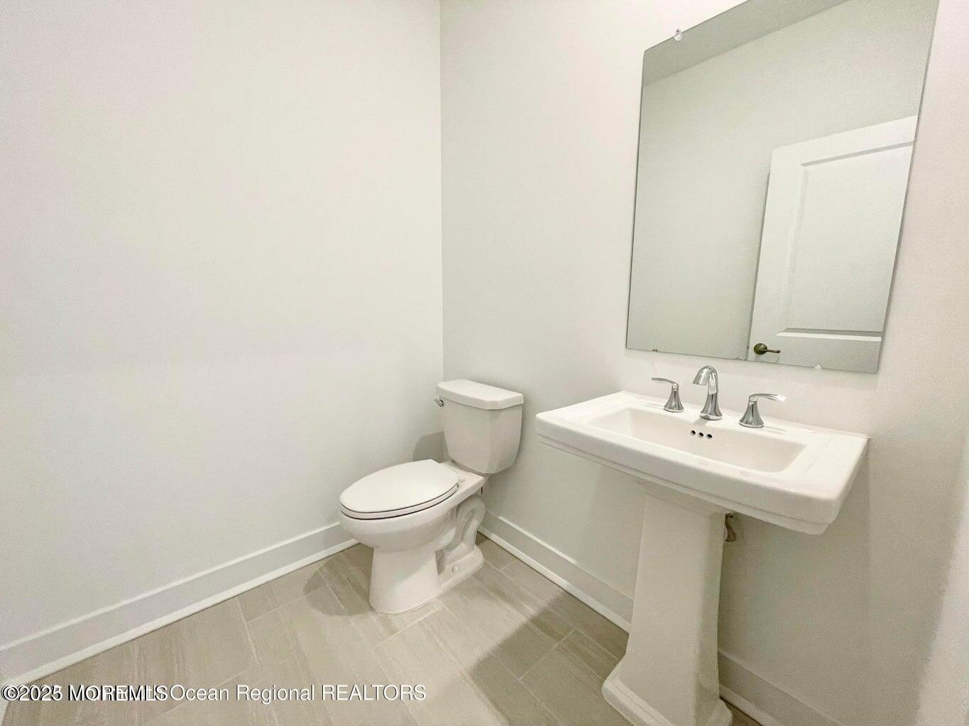 106 Woolley Court Oakhurst, NJ 07755 - Photo 13 of 17 a bathroom with a toilet a sink and a mirror