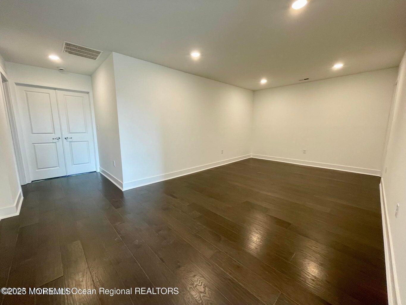 106 Woolley Court Oakhurst, NJ 07755 - Photo 14 of 17 an empty room with wooden floor