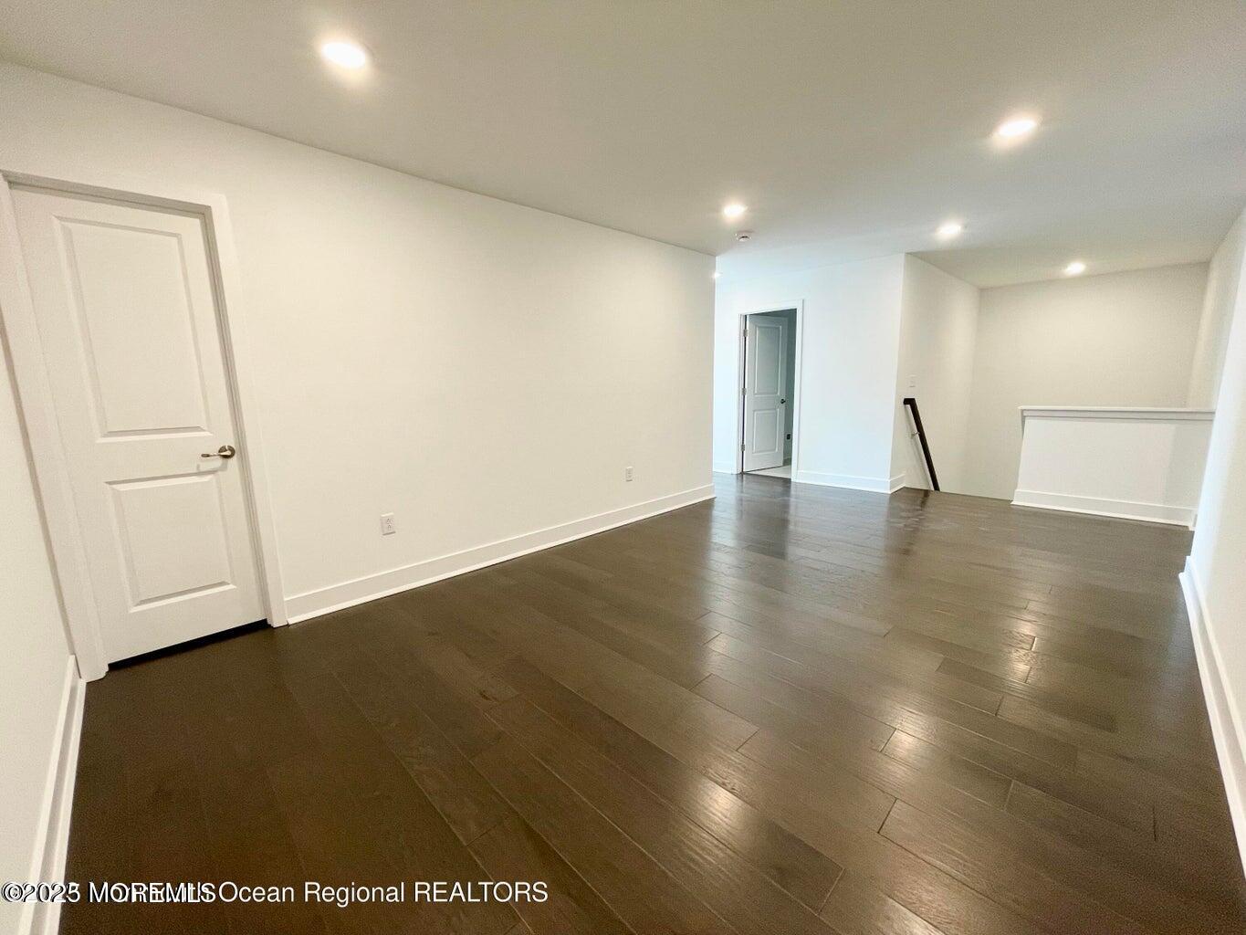 106 Woolley Court Oakhurst, NJ 07755 - Photo 2 of 17 a view of an empty room with wooden floor