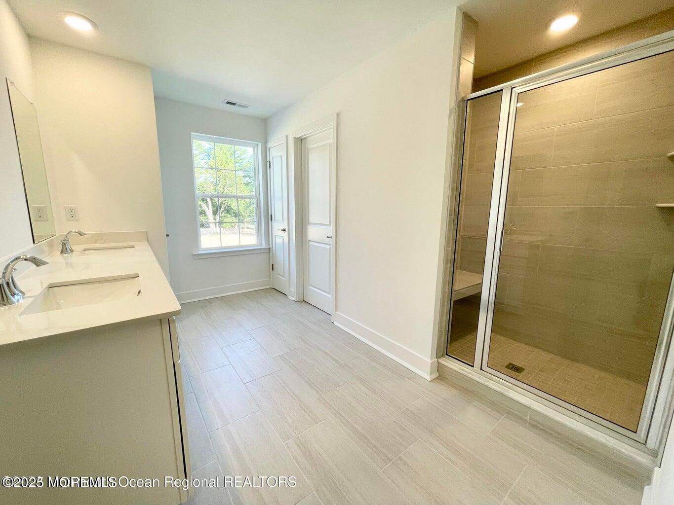 106 Woolley Court Oakhurst, NJ 07755 - Photo 3 of 17 a bathroom with a sink and a mirror