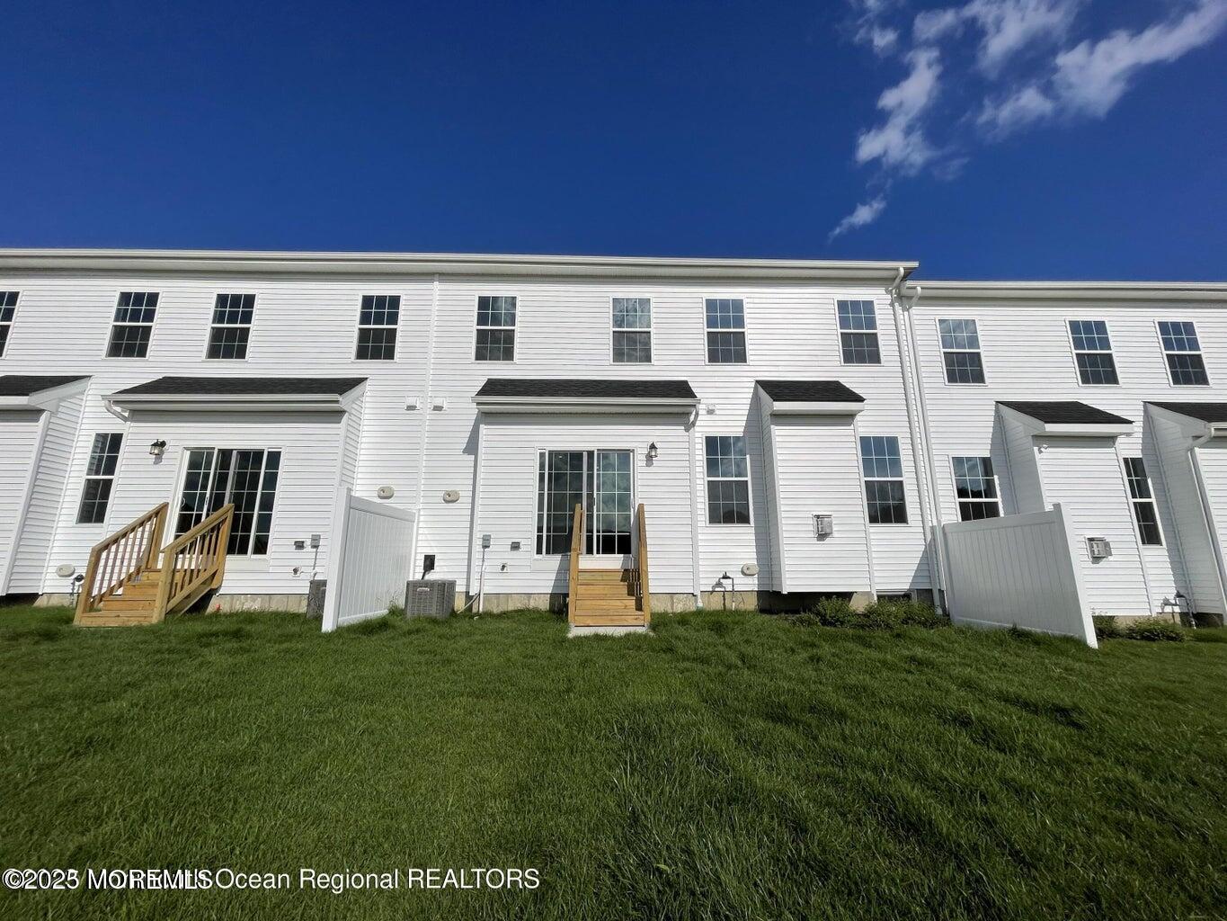 106 Woolley Court Oakhurst, NJ 07755 - Photo 6 of 17 a front view of a building with garden
