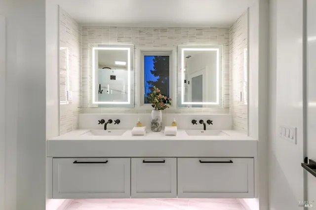 a bathroom with a sink vanity and mirror