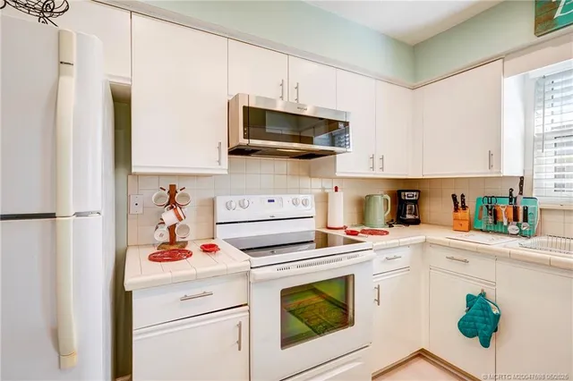 a kitchen with a stove a sink and a microwave