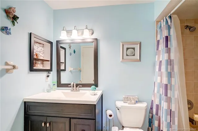 a bathroom with a sink mirror and vanity
