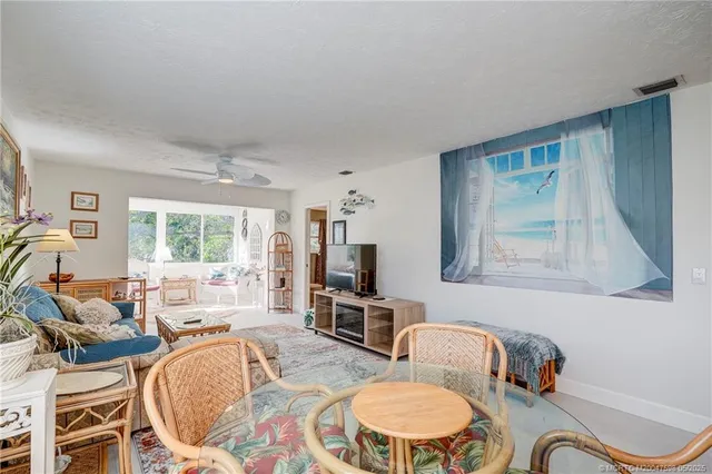 a bedroom with furniture and a large window