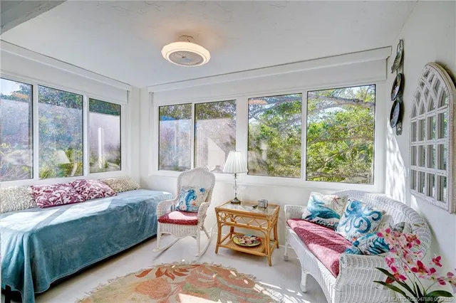 a living room with furniture and a dining table with wooden floor