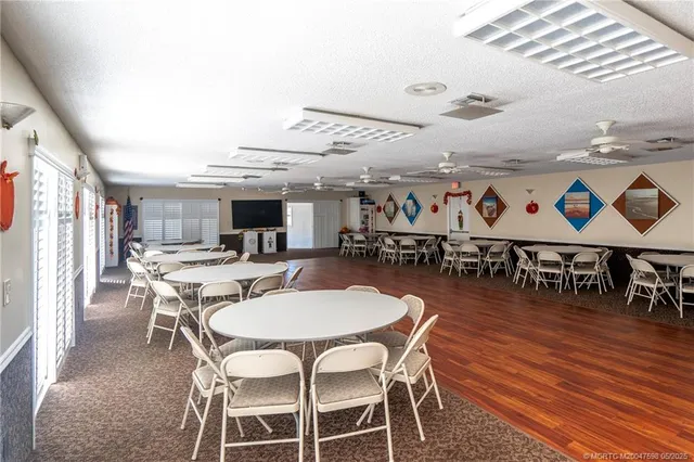 a dinning room with furniture wooden floor and a chandelier