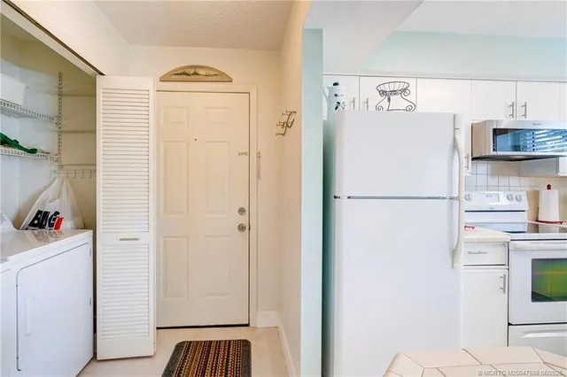 a white refrigerator freezer sitting inside of a kitchen