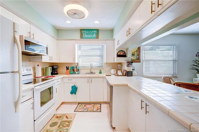 a kitchen with a sink cabinets and window