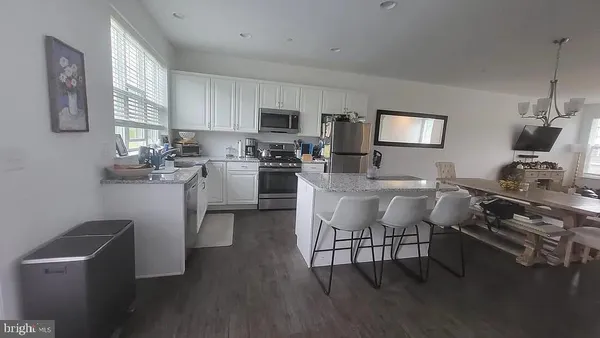 a kitchen with a dining table chairs and view kitchen