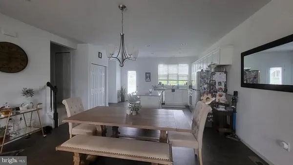 a dining room with furniture and wooden floor