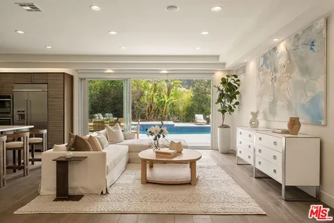 a kitchen with stainless steel appliances kitchen island granite countertop a table and chairs