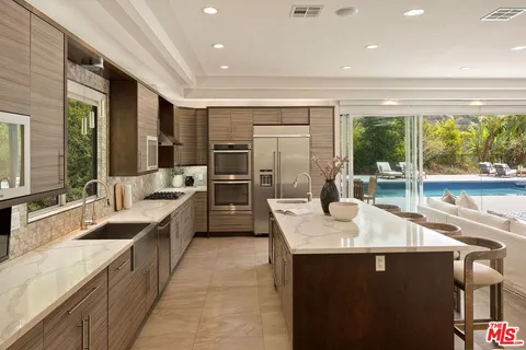 a kitchen with a sink stove and refrigerator