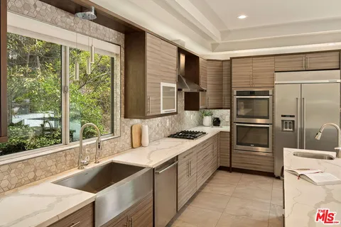 a living room with furniture and kitchen view