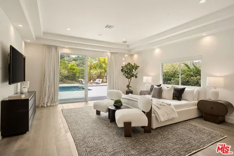 a bedroom with a bed and a television
