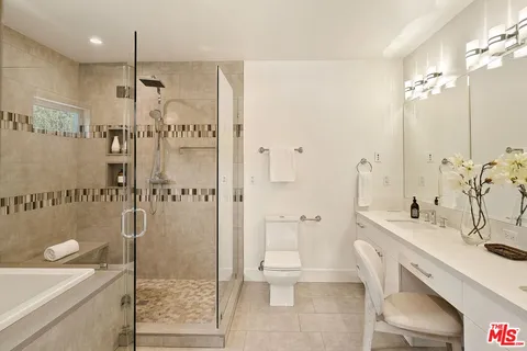 a bathroom with a sink vanity and a mirror
