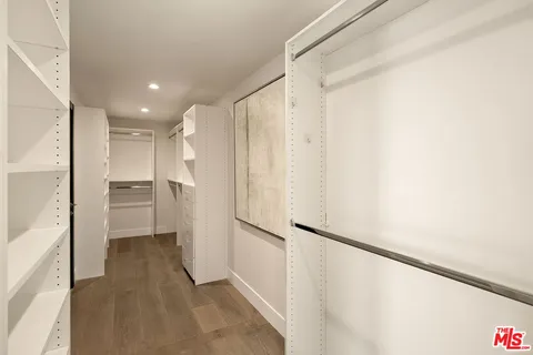 a bedroom with bed and a night stand