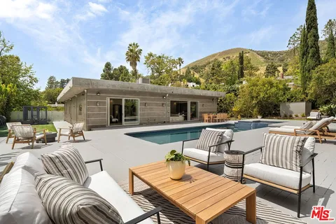 a view of a patio with swimming pool table and chairs