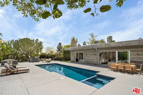 a view of a patio with swimming pool table and chairs