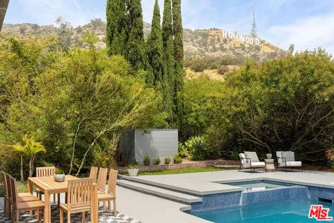 a view of a swimming pool with chairs and tables