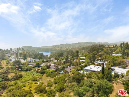 an aerial view of a house with a yard and garden