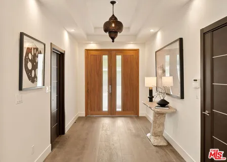 a living room with furniture wooden floor and a large window