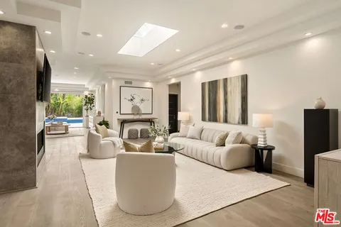 a living room with furniture fireplace and a flat screen tv