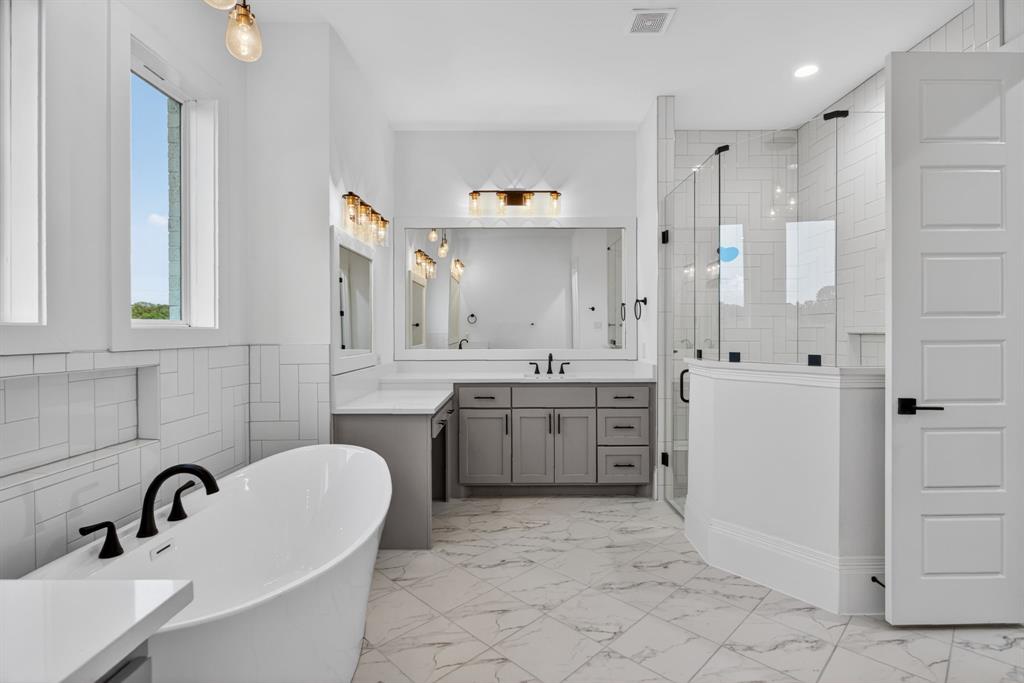 7798 Barber Rnch Road Fort Worth, TX 76126 - Photo 24 of 40 a bathroom with a tub sink and mirror