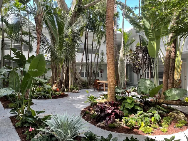 a bunch of flowers and trees in a garden