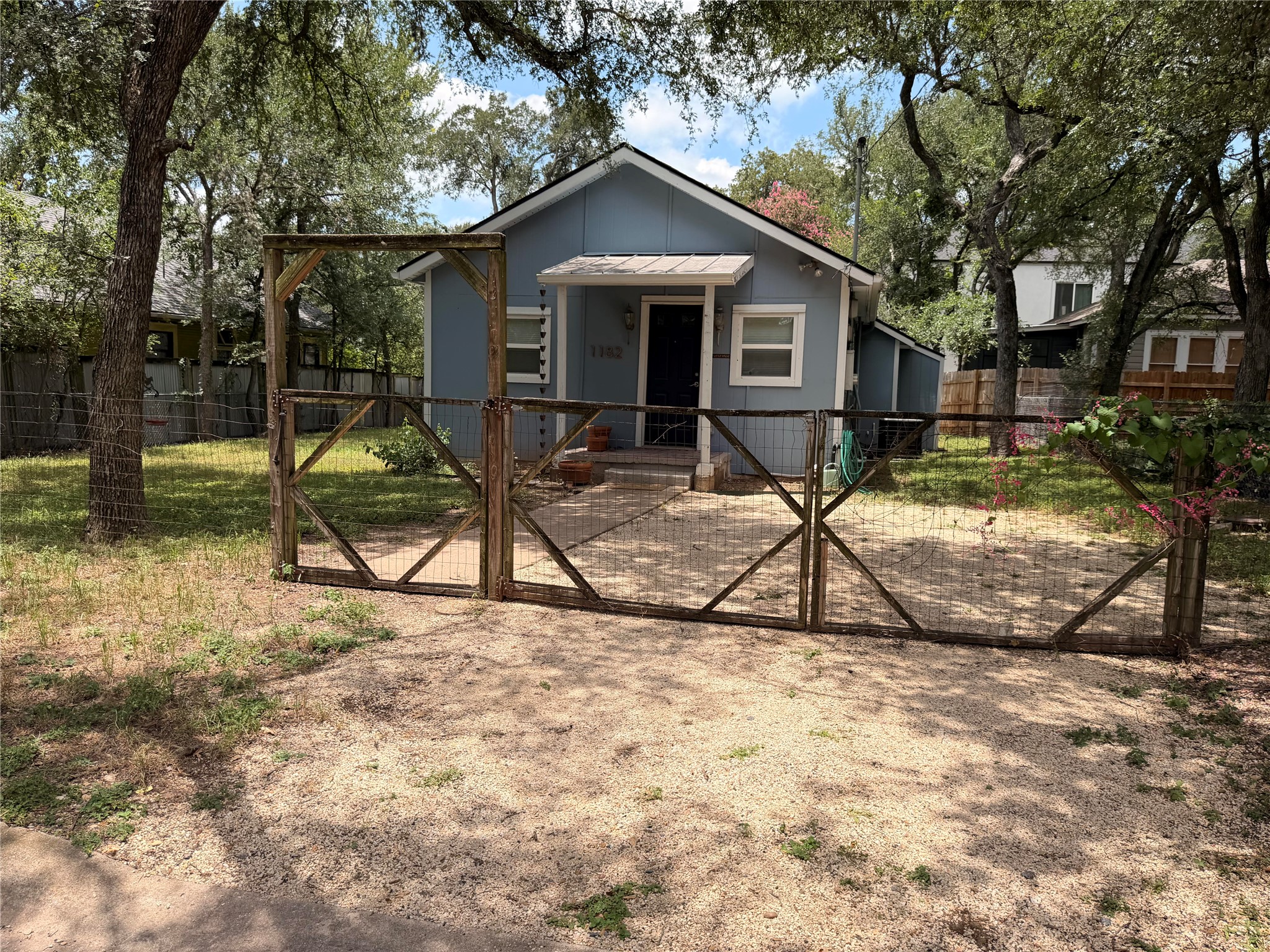 1182 Pandora Street Austin, TX 78702 - Photo 17 of 19 Charming light blue residence nestled among mature trees with a fenced, private yard.