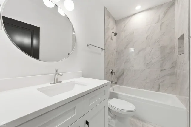 a bathroom with a sink a toilet and a mirror