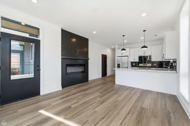 a view of kitchen with refrigerator microwave and stove