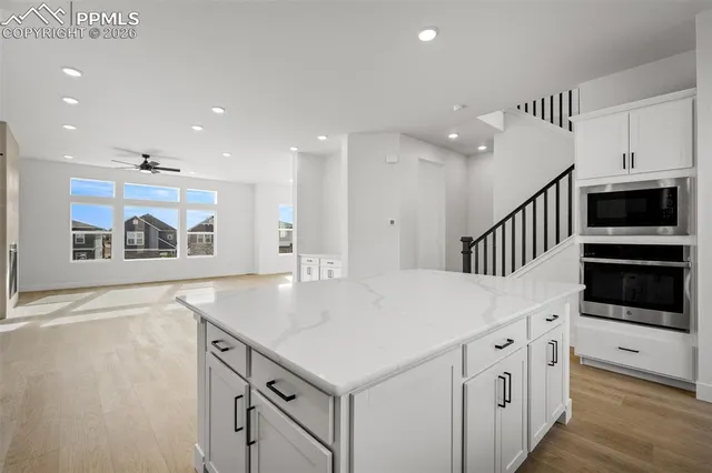 a kitchen with stainless steel appliances a white stove top oven and a refrigerator