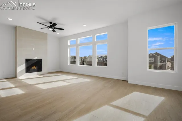 a view of an empty room with a window and a fireplace