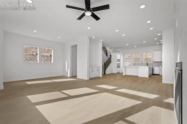 a view of a kitchen with a refrigerator and window