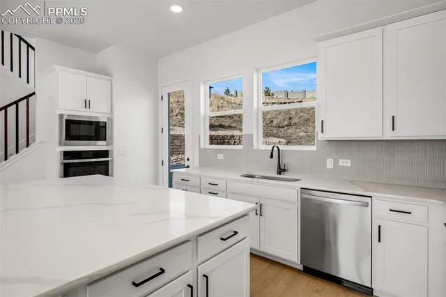 a kitchen with a sink cabinets and window
