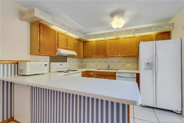 a kitchen with cabinets appliances and a sink