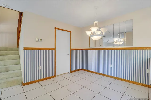 a kitchen with a refrigerator a stove a sink dishwasher and wooden cabinets with wooden floor