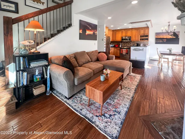 a living room with furniture and a wooden floor