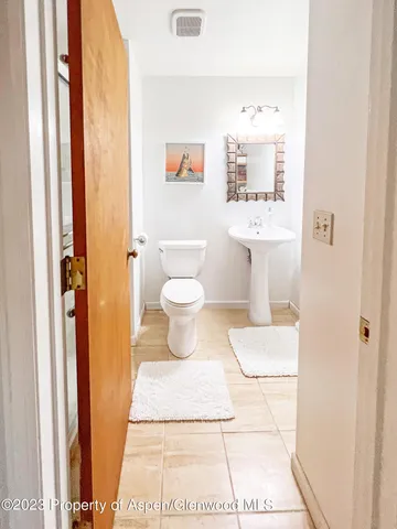 a spacious bedroom with a bed and a lamp