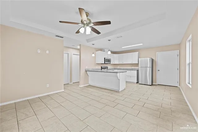 a view of a kitchen with a sink and a refrigerator