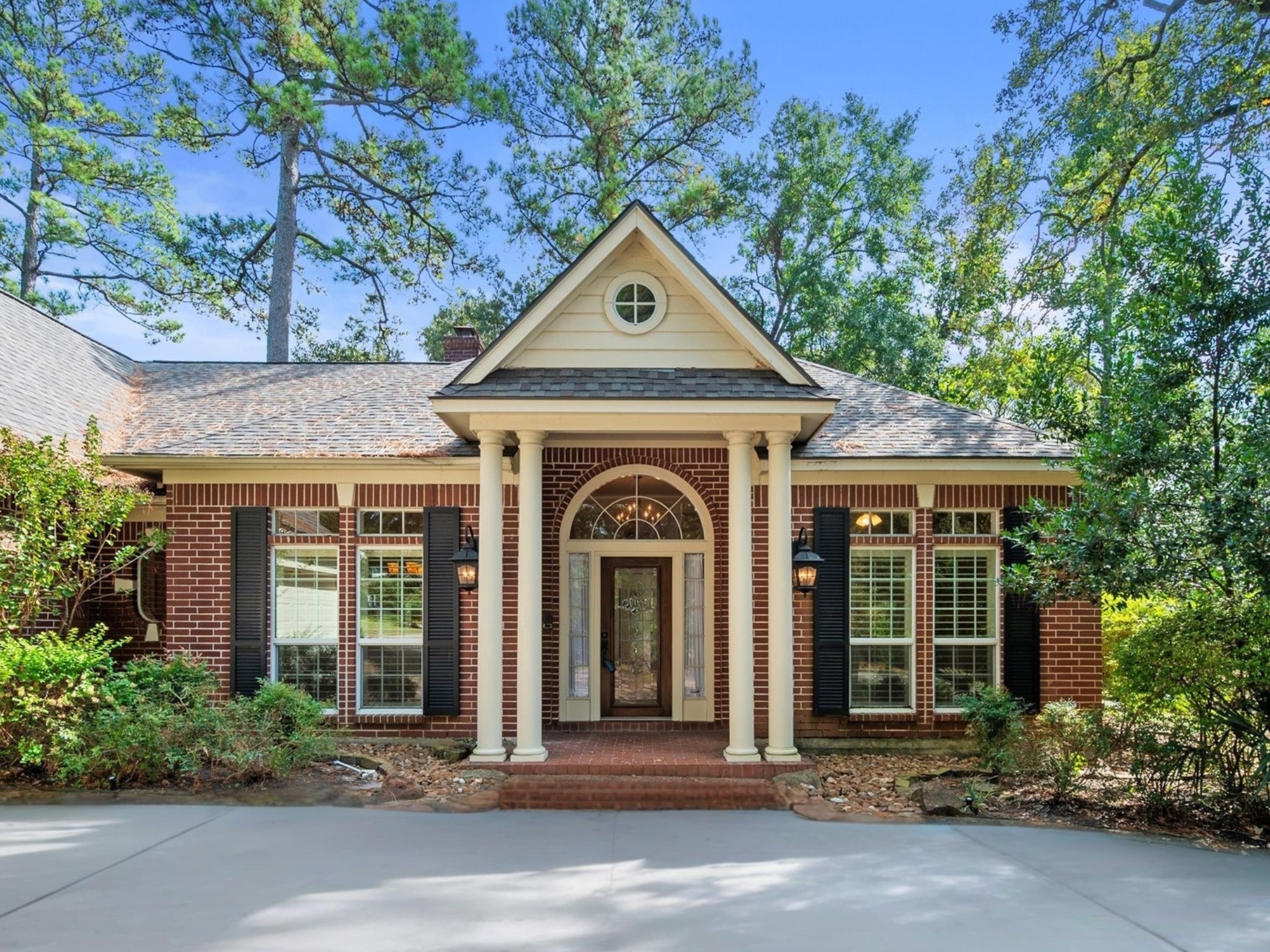 a front view of a house with a garden