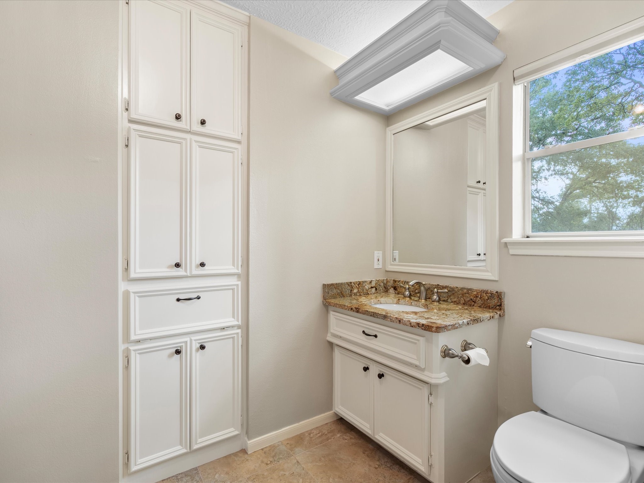 7 Wellesley Drive Conroe, TX 77304 - Photo 17 of 34 a bathroom with a granite countertop toilet and a sink