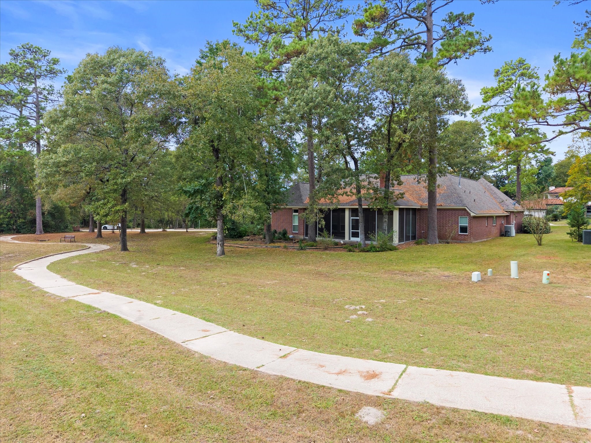7 Wellesley Drive Conroe, TX 77304 - Photo 26 of 34 a view of a house with swimming pool