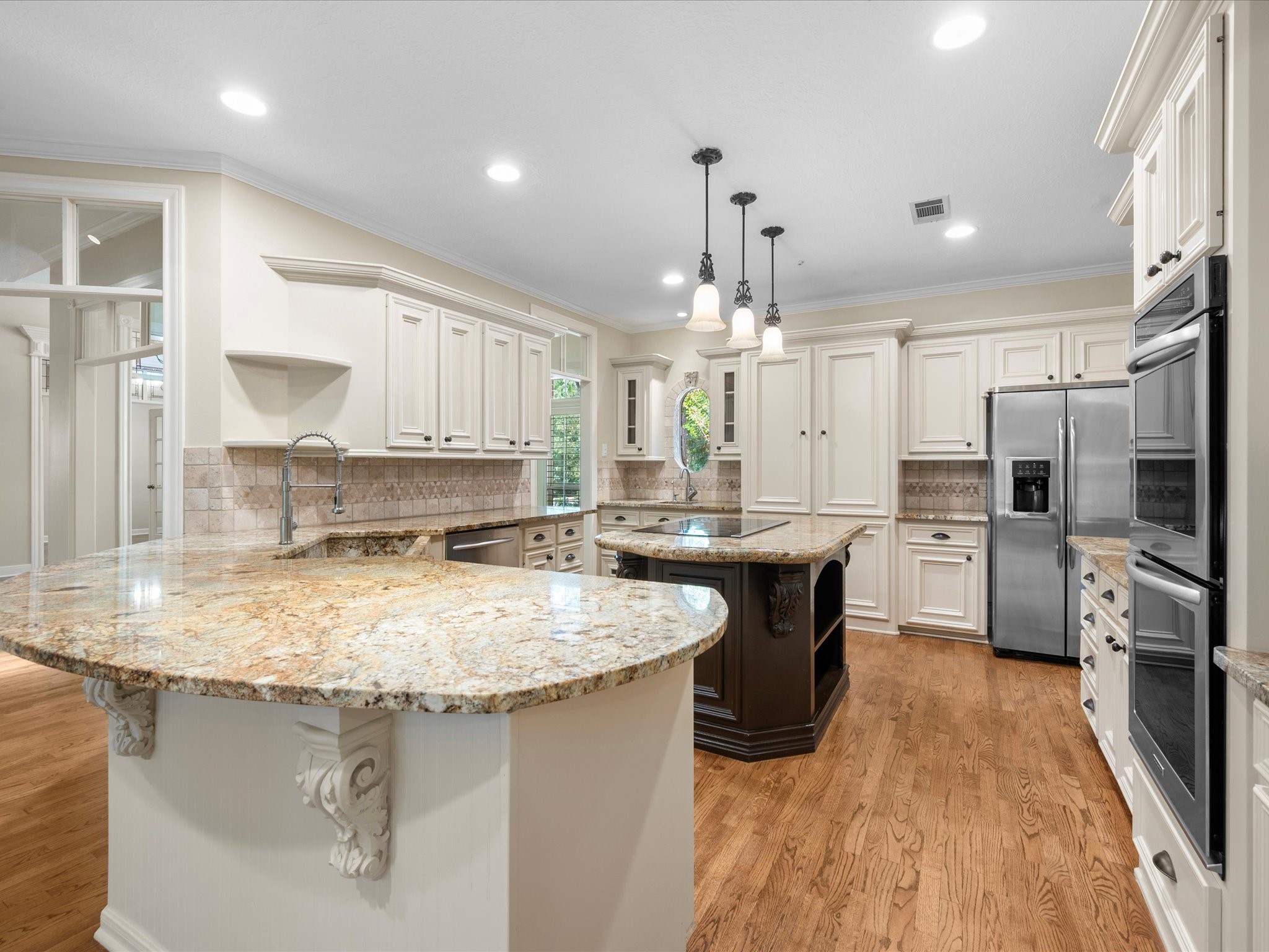 7 Wellesley Drive Conroe, TX 77304 - Photo 4 of 34 a kitchen with stainless steel appliances granite countertop a sink stove and refrigerator