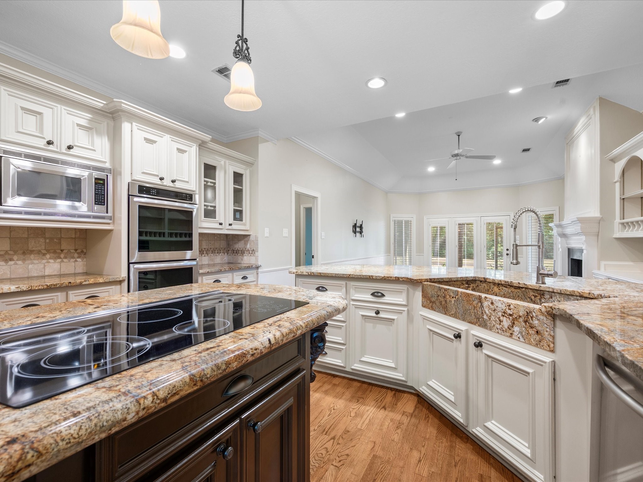 7 Wellesley Drive Conroe, TX 77304 - Photo 6 of 34 a kitchen with stainless steel appliances granite countertop a stove a sink and a microwave