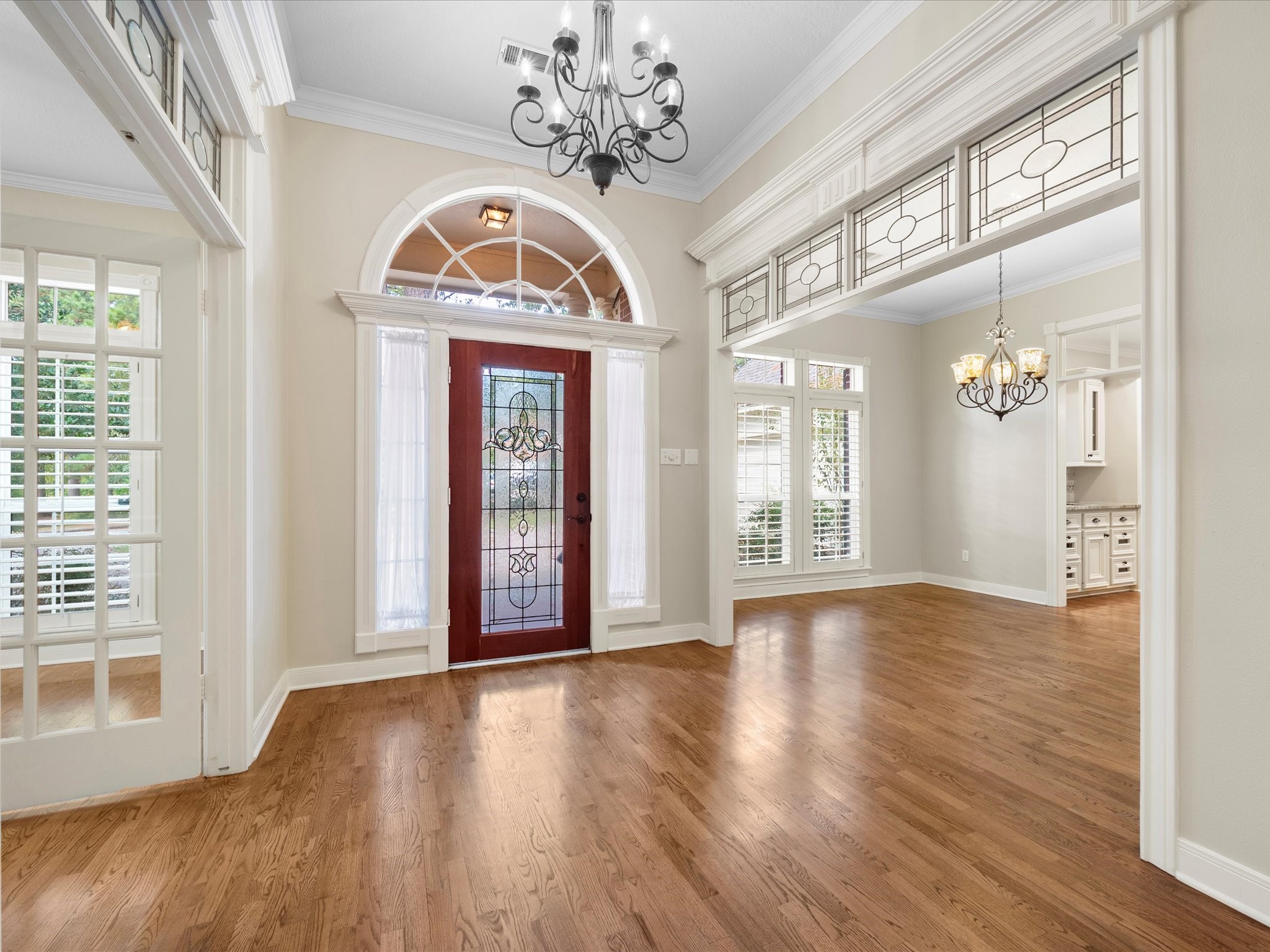 7 Wellesley Drive Conroe, TX 77304 - Photo 9 of 34 a view of an entryway with wooden floor and a front door