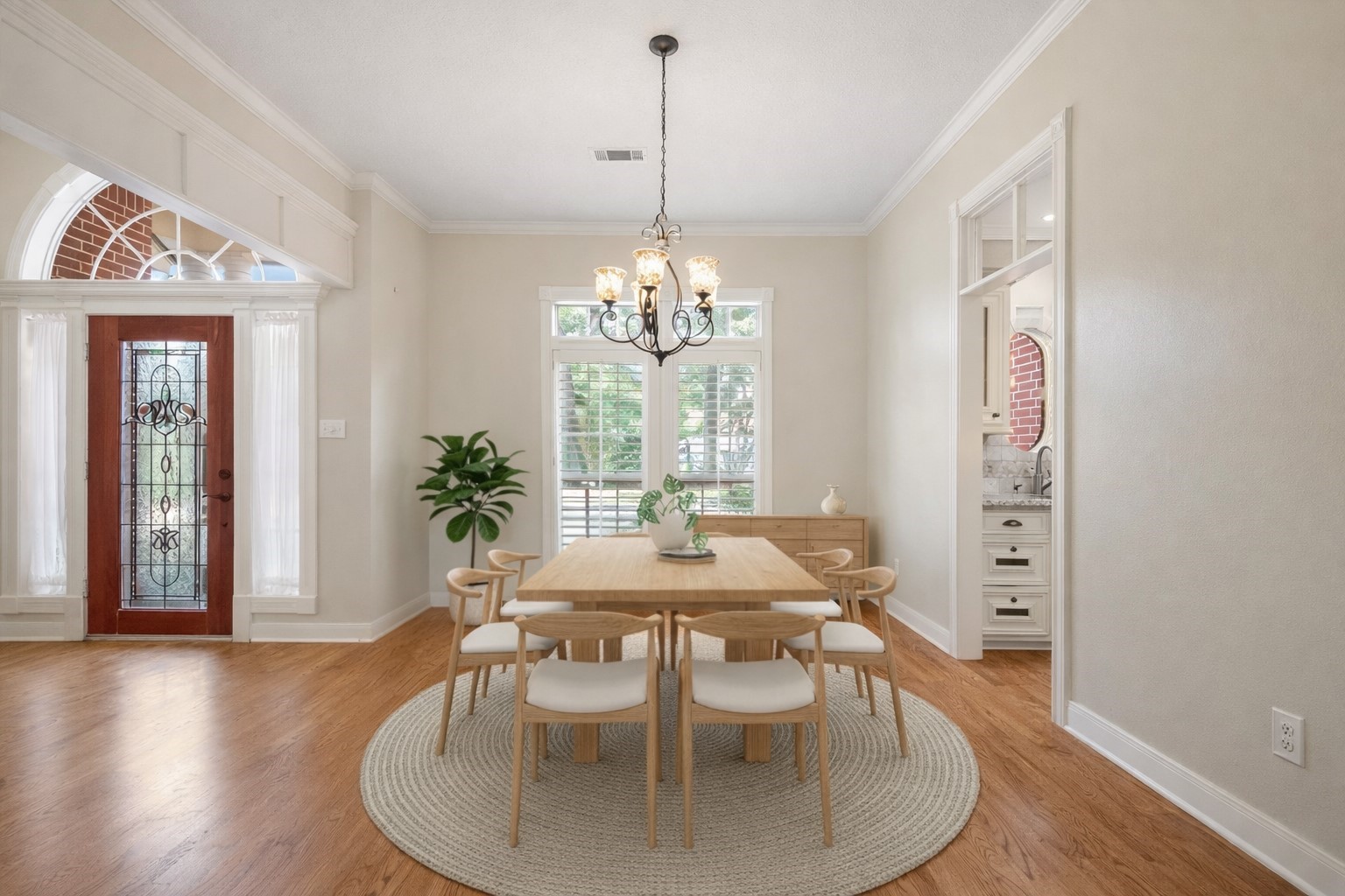 7 Wellesley Drive Conroe, TX 77304 - Photo 10 of 34 a dining room with furniture a chandelier and wooden floor
